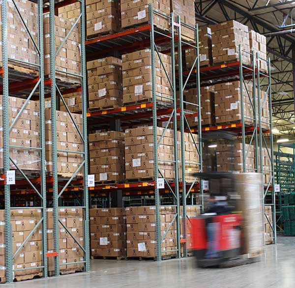 Trucking company employee handling imported goods in customs bonded warehouse